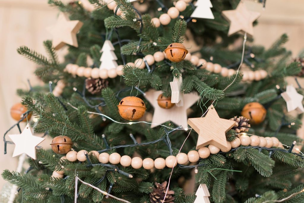 wooden beaded garlands hanging around christmas tree